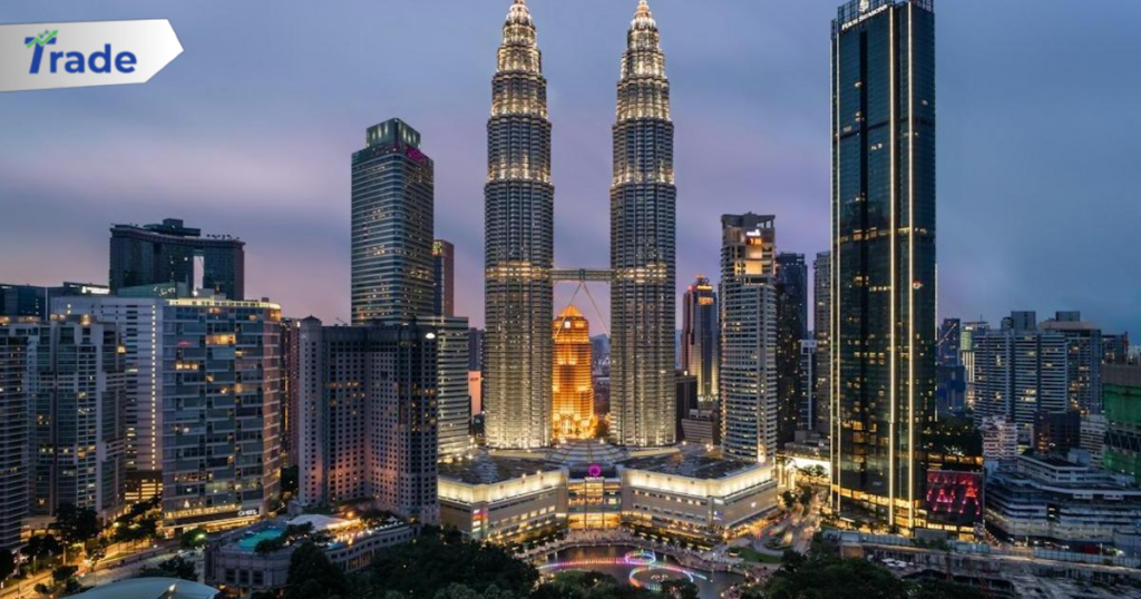 The Petronas Towers illuminated at night above a park in Kuala Lumpur, Malaysia
