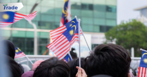 a group of people holding malaysia and malaysia flags