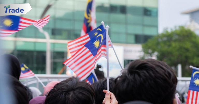 a group of people holding malaysia and malaysia flags