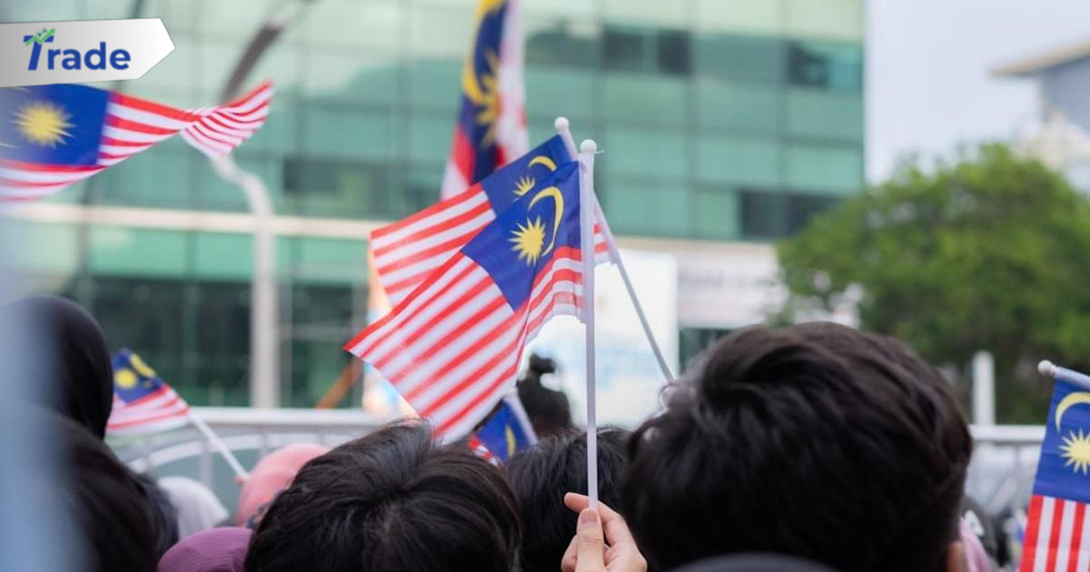 a group of people holding malaysia and malaysia flags